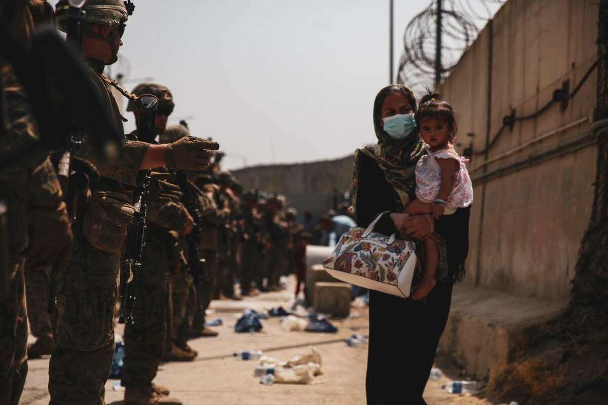 1700 Marines With The 24th Expeditionary Unit Meu Guide An Evacuee During An Evacuation At Hamid Karzai International Airport 8 Of 8